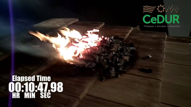 CeDUR roofing product undergoing a fire-resistance test with burning debris on the roof surface.