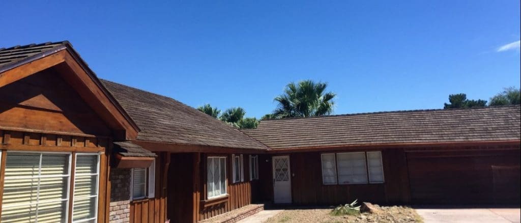 Wood-sided home with weathered cedar shake roof.