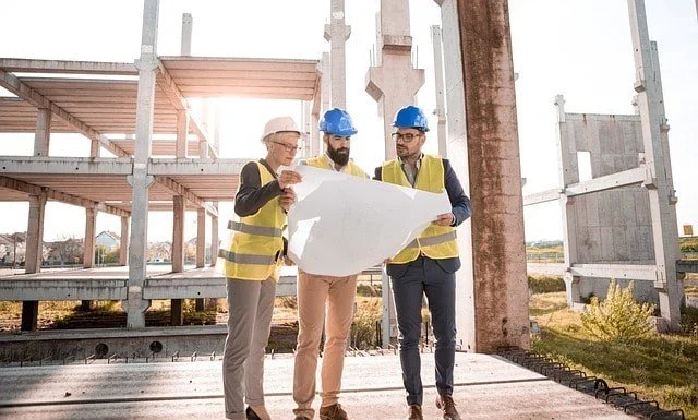 Engineers looking over the plans of a passive house. 