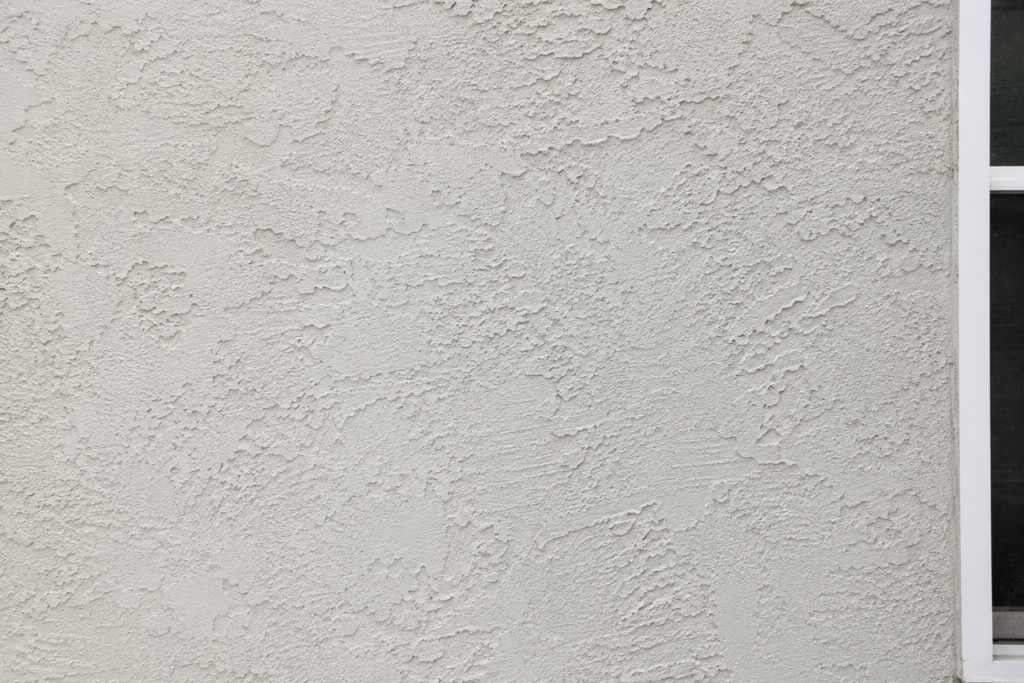 Textured stucco exterior wall finish on a residential home.