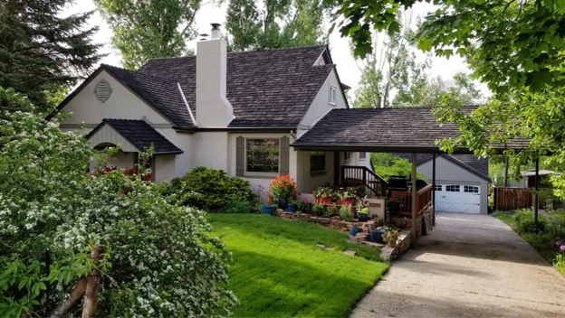 Cottage-style home with landscaped yard.