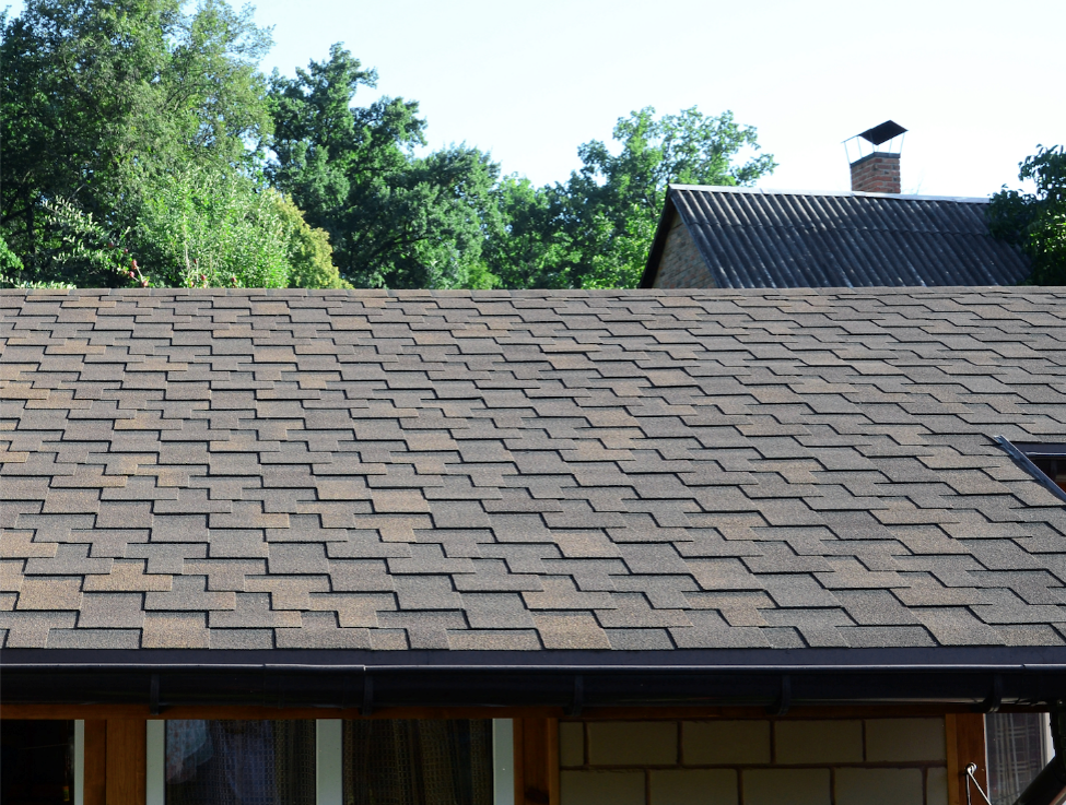 A close up look at an asphalt roof on a house.