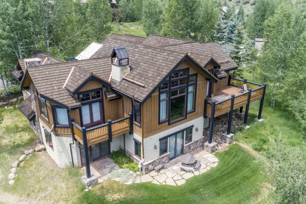 Mountain-style home with multi-level decks and shingle roof.