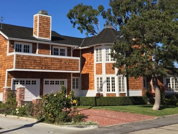 Shiloh home with brown siding and cedar shake roof.