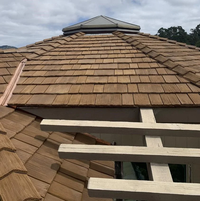 Close-up of natural cedar shake roof with roof cupola.