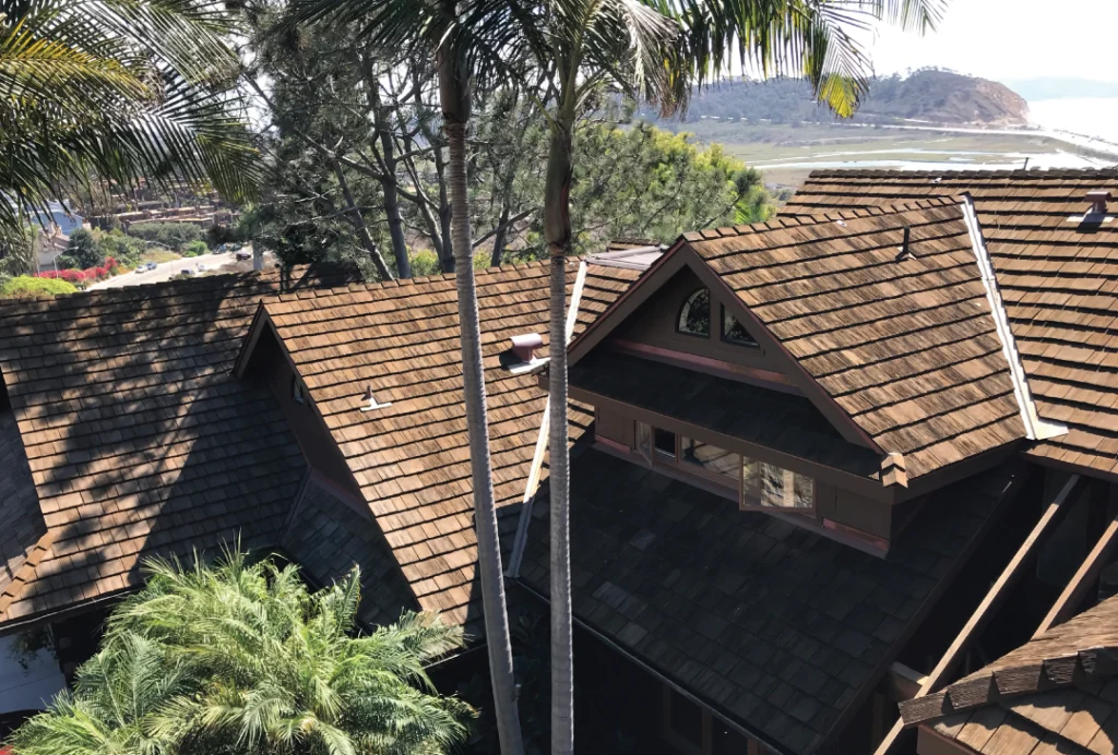 Residential property featuring CEDUR roofing with a natural wood shake appearance.