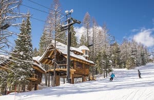Snow Bear Chalets beneath a ski lift in a mountain setting.