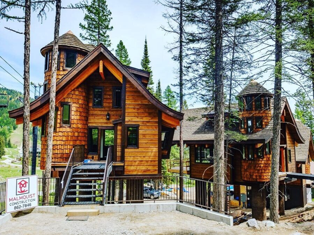 Mountain homes with a natural, brown cedar shake siding. 