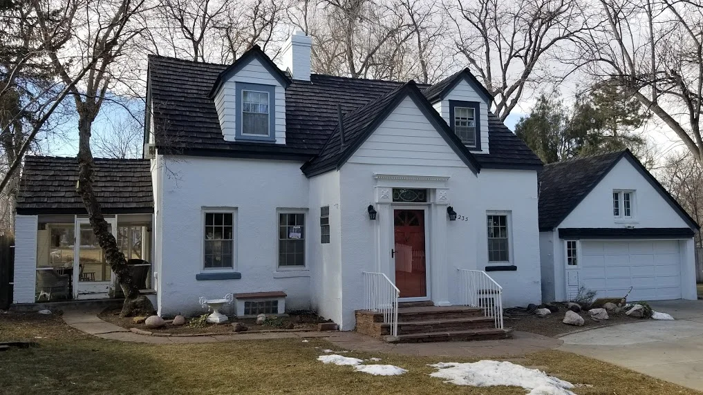 A white house with a black roof.