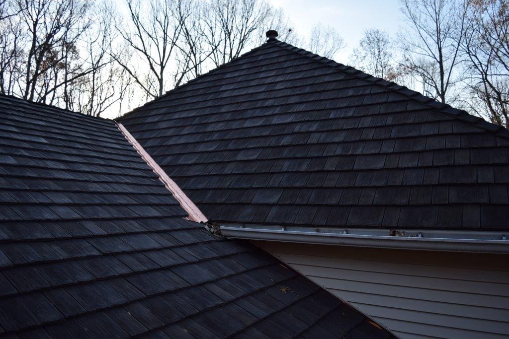 Close-up view of synthetic cedar shake shingles on residential roof.