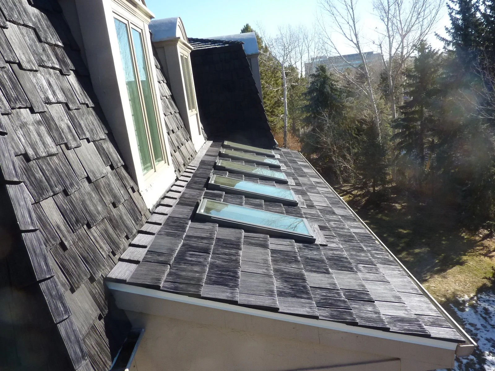 Mansard roof with architectural shingles.