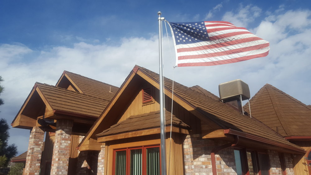 Cedar-look Live Oak roof in Wyoming with an American flag flying above.
