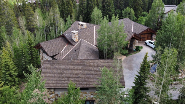CEDUR Walden roof on a mountain home in Colorado, installed by Kidd Roofing surrounded by tall evergreen trees.