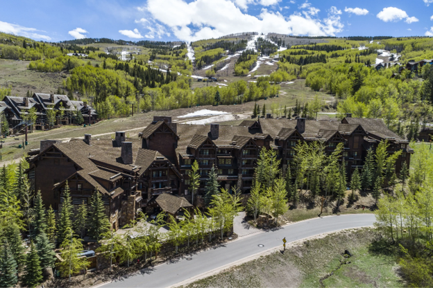Cohesive commercial exterior featuring synthetic wood shakes to top off a cozy mountain resort.
