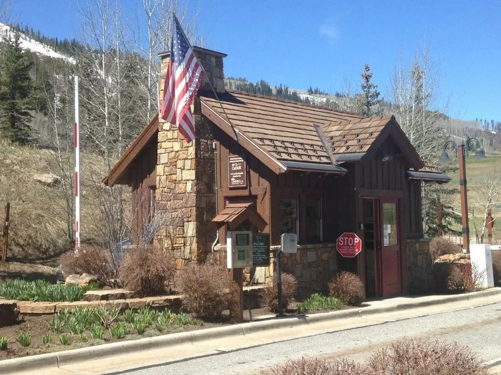 State park guard station with board and batten siding, stone accents, and CEDUR Live Oak synthetic shake roofing.